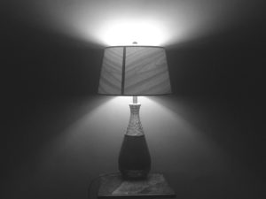 A lamp casting shadows on a wall